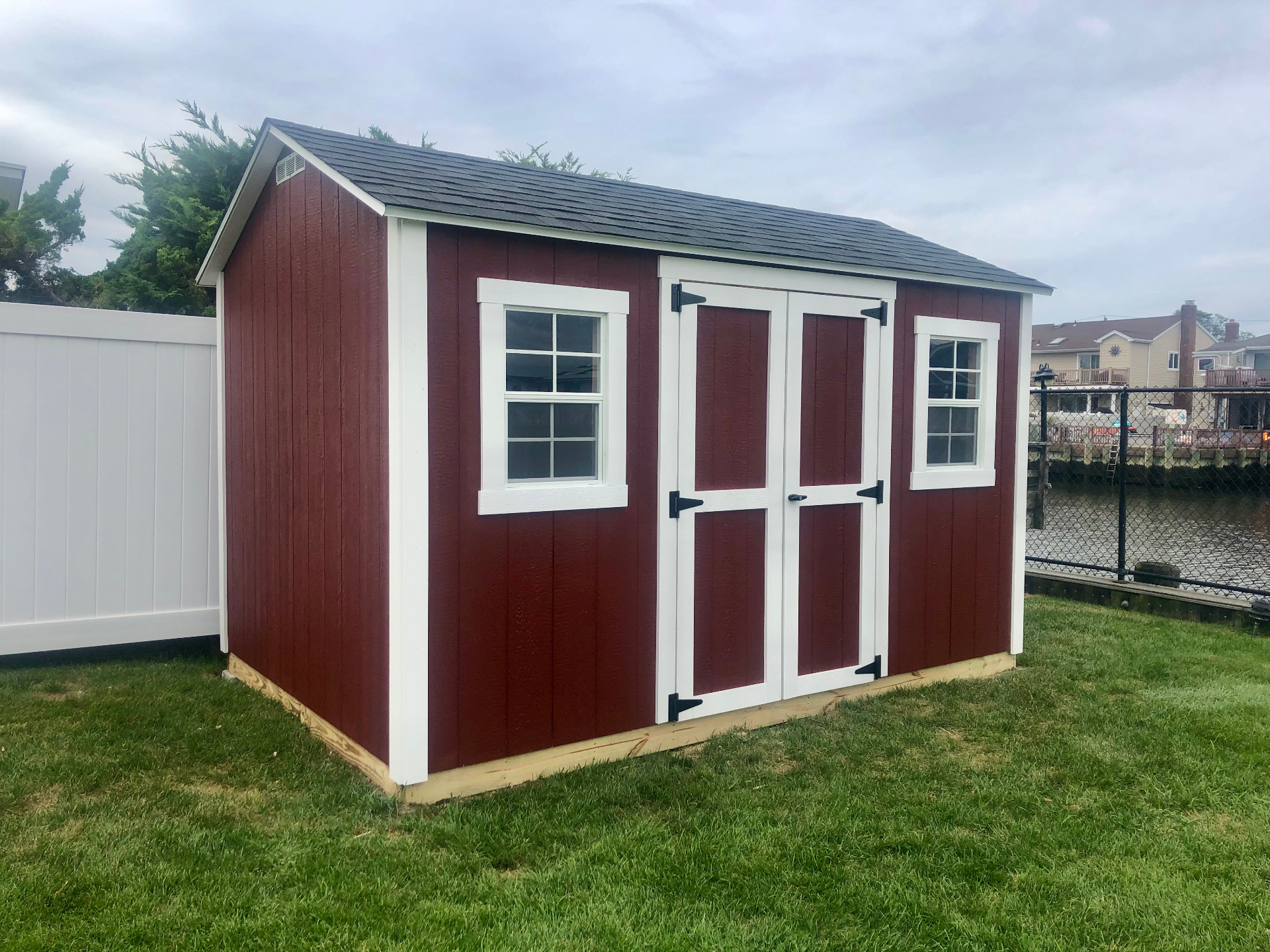 Custom red storage shed with white trim built on-site in Sellersburg, Indiana